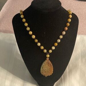 Elegant Beaded Necklace with Carved Pendant
